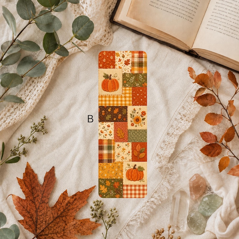 Autumn patchwork bookmark featuring pumpkins, yellow sunflowers, brown leaves and plaid squares in shades of orange, green and golden yellow.