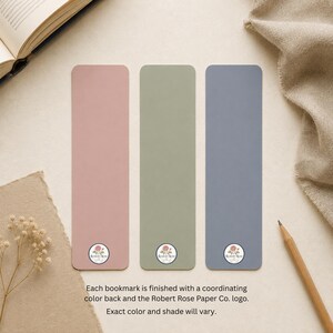 Reverse sides of three bookmarks in coordinating dusty rose, sage green and slate blue, each finished with the Robert Rose Paper Co. logo near the bottom.