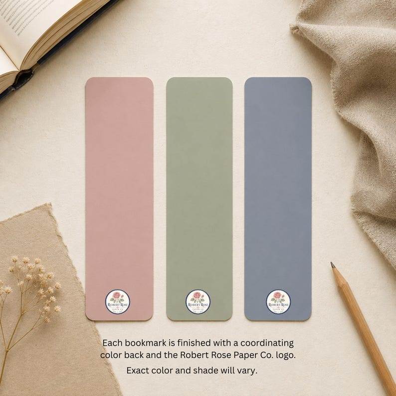 Reverse sides of three bookmarks in coordinating dusty rose, sage green and slate blue, each finished with the Robert Rose Paper Co. logo near the bottom.