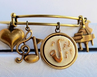 Let The Music Flow - vintage saxophone glass button element bracelet, antique brass expandable charm bangle bracelet