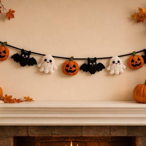 May include: A Halloween-themed garland featuring crocheted figures strung along a black cord. The figures include white ghosts with pink cheeks, orange jack-o'-lantern pumpkins with green stems, and black bats with white eyes and small wings.