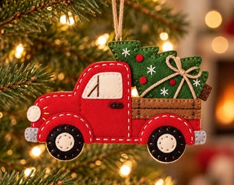 May include: A felt Christmas tree ornament shaped like a red pickup truck carrying a green Christmas tree in its brown truck bed. The truck features white wheels, a white window, and a jute twine loop for hanging. The tree has white stitched snowflakes.