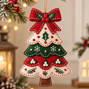 May include: A layered felt Christmas tree ornament featuring alternating white, green, and red scalloped tiers. The ornament is decorated with embroidered holly leaves, white snowflakes, and small red and white beads, topped with a red bow.