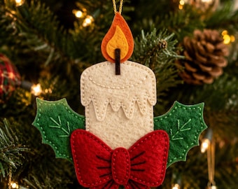 May include: A felt Christmas tree ornament shaped like a cream-colored candle with a yellow and orange flame. The candle is decorated with two green felt holly leaves and a large red felt bow at the base, all attached with visible stitching.