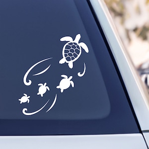 May include: White vinyl decal of four sea turtles swimming in a line. The largest turtle is at the top of the design, followed by three smaller turtles. The turtles are swimming in a wavy pattern.
