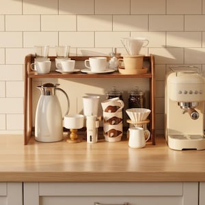 May include: A wooden countertop shelf holding white and beige ceramic mugs, glass tumblers, a white thermal carafe, a manual coffee grinder, glass jars with coffee beans, a white ceramic pour-over dripper, and a small white creamer jug.