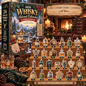 May include: A 2026 Whisky Advent Calendar box featuring a winter landscape and 24 numbered whisky-themed charms displayed on a tiered wooden stand. The charms include illustrations of bottles, barrels, glasses, and festive icons with text labels.