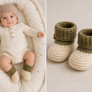May include: A pair of handmade crochet baby booties featuring a cream-coloured foot and a ribbed olive green cuff. Each bootie is accented with a single small wooden button on the side. The booties are crafted with a thick, textured yarn construction.