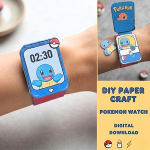 May include: A blue paper craft watch featuring a Squirtle character on the screen with the time 02:30 displayed. The watch includes a flip-up cover with a Charmander illustration and the Pokémon logo, along with a separate Squirtle paper cutout.