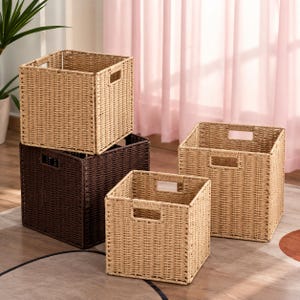 May include: A set of three square storage baskets with a woven texture and integrated handles. Two baskets are light tan, and one basket is dark brown. The baskets are arranged in a cluster, with one light tan basket stacked on the dark brown one.