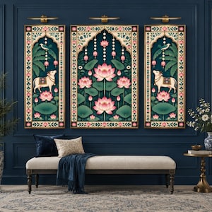 May include: A triptych of three rectangular wall art panels featuring a central image of pink lotus flowers and two side panels depicting a white cow standing amidst lotus blossoms, all framed in a decorative border with floral motifs.