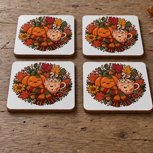 May include: A set of four square coasters with rounded corners, each featuring a colourful illustration of a smiling orange pumpkin, a steaming mug of cocoa, a striped scarf, acorns, and autumn leaves in shades of red, orange, and yellow.
