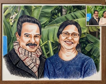 May include: A colored pencil portrait of a couple in a wooden frame. The man wears a dark coat and a plaid scarf, while the woman wears a blue sweater and glasses. The background features green banana leaves. A small reference photo is in the corner.