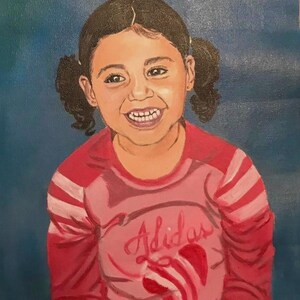 May include: An oil painting on canvas depicting a smiling child with dark hair styled in two pigtails. The child wears a long-sleeved pink and red shirt with the Adidas logo and a graphic design printed on the front against a solid blue background.