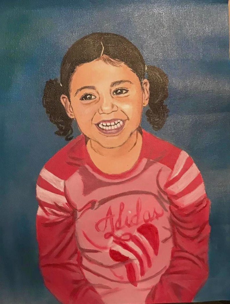 May include: An oil painting on canvas depicting a smiling child with dark hair styled in two pigtails. The child wears a long-sleeved pink and red shirt with the Adidas logo and a graphic design printed on the front against a solid blue background.