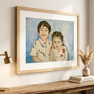May include: A framed colored pencil portrait of a young boy and a young girl. The boy wears a light-colored short-sleeved shirt with a blue dinosaur pattern. The girl wears a light-colored sleeveless top with a red floral pattern. The background is blue.