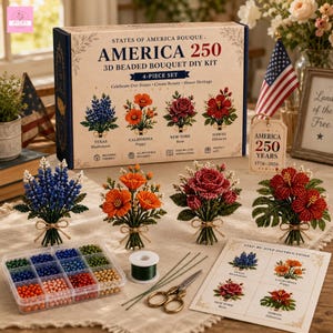 May include: A 3D beaded bouquet DIY kit box labelled America 250, featuring four finished beaded flower arrangements: a blue Texas bluebonnet, orange California poppy, red New York rose, and red Hawaii hibiscus. Includes a bead organiser, wire, and instructions.