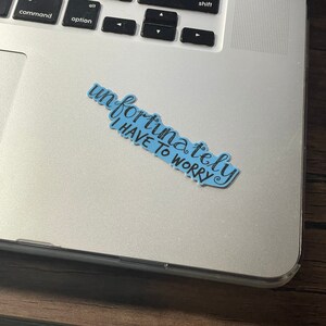 Pu&ograve; includere: Un adesivo blu con il testo "Sfortunatamente devo preoccuparmi" scritto in corsivo nero.