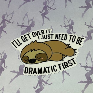 May include: A white sticker with a brown sloth sleeping with the text "I'll get over it I just need to be dramatic first."