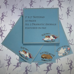 May include: A blue notepad with 30 pages featuring three different designs of animals with the text "I'll get over it, I just need to be dramatic first". The animals are a unicorn, a sloth, and a cat.