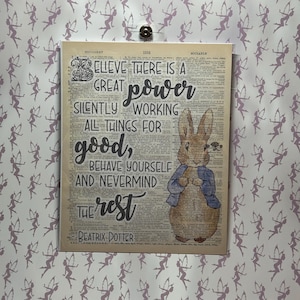 May include: A vintage dictionary page with a quote from Beatrix Potter featuring a cartoon illustration of Peter Rabbit. The quote reads: "Believe there is a great power silently working all things for good, behave yourself and nevermind the rest."