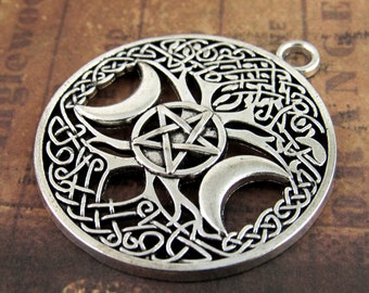 May include: Silver pendant featuring a Celtic knot design with a tree of life motif, three crescent moons, and a pentagram.