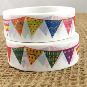 May include: Two rolls of decorative washi tape. Each roll is white with a colorful banner pattern of triangles in red, orange, yellow, green, blue, and purple. The tape is stacked on top of each other.