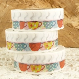 May include: Three rolls of white washi tape with a repeating pattern of colorful teacups and steam.