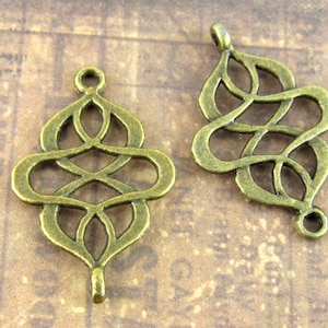 May include: Two antique bronze metal charms with intricate Celtic knot designs. The charms are open at the top and bottom, allowing them to be attached to jewelry or other crafts.