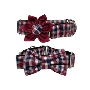 May include: A red and blue plaid dog collar with a matching bow tie. The collar has a silver buckle and the bow tie is tied in a classic bow shape.