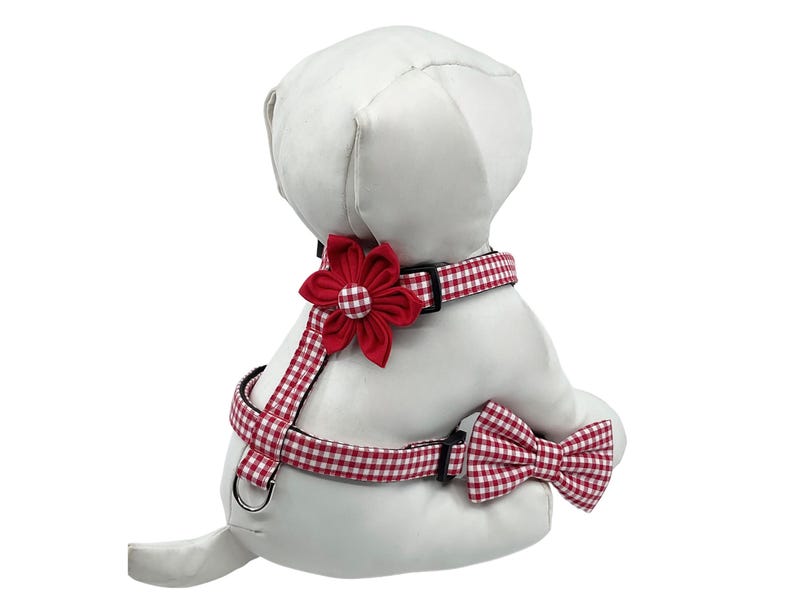 Red Gingham Dog Harness With Optional Flower Or Bow Tie, Adjustable Pet Harness Sizes XS, S, M. All straps are sewn on top of black webbing to prevent the fabric from stretching out. I use light interfacing, plastic triglide slides to adjust the size, quality nickel plated d rings and a  side release buckle. The red flower and matching gingham bow tie are attached with double sided hook and loop for easy on and off.