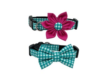 May include: Two pet collars with matching accessories. One collar features a fuchsia flower, the other a bow tie. Both collars are teal and white gingham with black hardware and a metal D-ring.