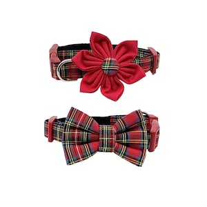 May include: Two pet collars with matching accessories. The top collar has a red flower accent, and the bottom collar has a red bow tie. Both collars feature a red, green, and yellow plaid pattern and red hardware.