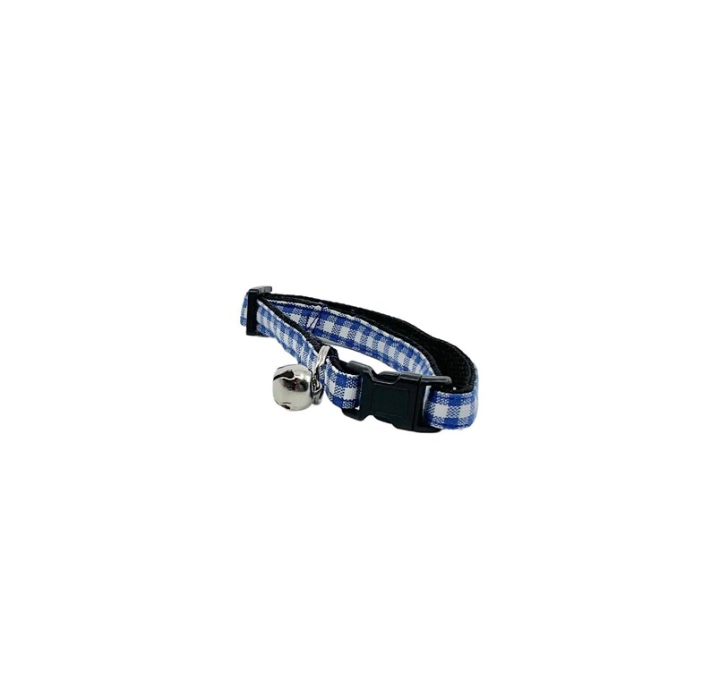 May include: Blue and white checkered cat collar with a silver bell.