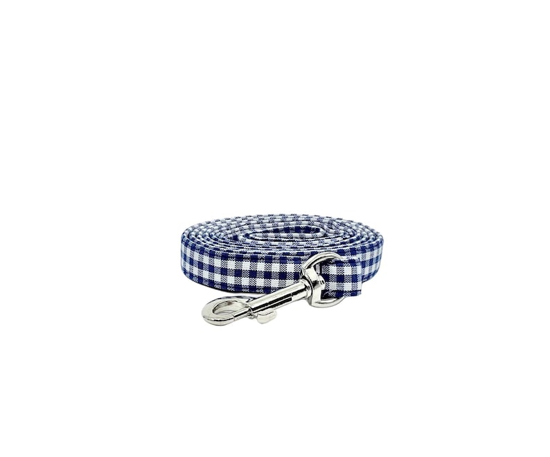 K&ouml;nnte beinhalten: Eine blaue und wei&szlig;e Gingham-Hundeleine mit einem silbernen Clip.