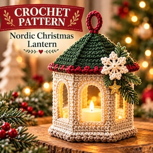 May include: A crochet pattern for a Nordic Christmas lantern featuring a beige hexagonal lantern with a dark green roof, a red trim, a white snowflake embellishment, and a small gold star. The text reads CROCHET PATTERN Nordic Christmas Lantern.