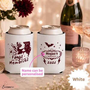 May include: Two white foam can coolers featuring dark red graphic prints. One cooler displays a vampire illustration with the text Fangs for the Memories. The other features a skull, bat, and lightning bolt design with the text Megan's Bachelorette 2026.