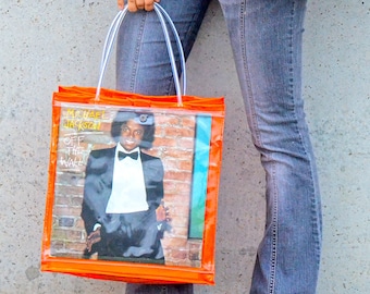 Tote con portada de disco LP de vinilo translúcido en naranja neón: elige la portada de tu álbum favorito y la opción de cambiar diariamente según tu estado de ánimo o estilo