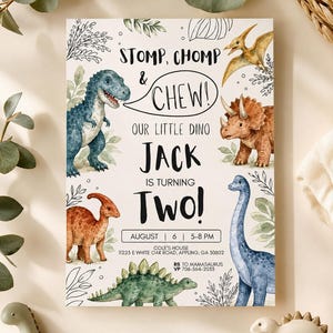 May include: A rectangular birthday invitation card featuring watercolor illustrations of various dinosaurs, including a blue T-Rex, a brown Triceratops, and a long-necked sauropod. The text reads: STOMP, CHOMP & CHEW! OUR LITTLE DINO JACK IS TURNING TWO!
