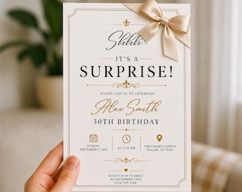 May include: A rectangular white invitation card with gold and black text reading Shhh... IT'S A SURPRISE! for Alex Smith's 30th birthday on Sunday, 7 September 2026, at 3:00 pm at The Garden Lounge, Dallas, TX, featuring a gold satin ribbon bow.