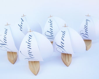 place cards, sailboats with names or numbers on sails