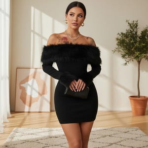 May include: A black off-the-shoulder mini dress featuring long sleeves with black faux fur trim at the cuffs and a matching black faux fur trim along the neckline. The dress is form-fitting and includes a small black clutch held in front.