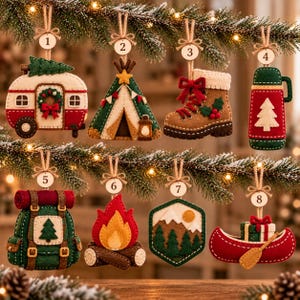 May include: A set of eight felt Christmas ornaments featuring camping and outdoor themes, including a camper, tent, hiking boot, thermos, backpack, campfire, mountain landscape, and canoe, each with a numbered wooden tag and twine hanger.