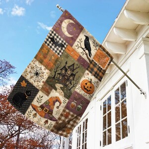 May include: A rectangular outdoor flag featuring a patchwork design with Halloween motifs including a black cat, a spider web, a haunted house, a jack-o'-lantern, a witch hat, a broom, a crescent moon, a bat, and a raven on a branch.