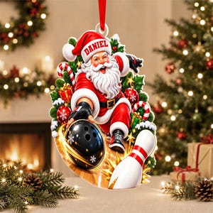 May include: A Christmas ornament featuring Santa Claus wearing a red hat with the name DANIEL printed on it. Santa is bowling with a black ball and a white pin, surrounded by green pine branches, red ornaments, and gift boxes.