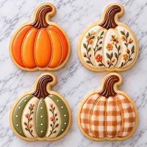 May include: Four pumpkin-shaped sugar cookies decorated with royal icing. One is solid orange, one is white with orange and green floral vines, one is sage green with white dots and floral vines, and one features an orange and white gingham pattern.