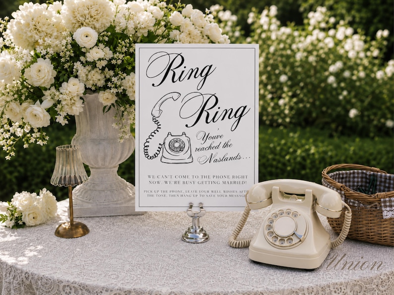 May include: A white rectangular sign with black text reading Ring Ring You've reached the Naslands... We can't come to the phone right now. We're busy getting married! Pick up the phone, leave your well wishes after the tone, then hang up.