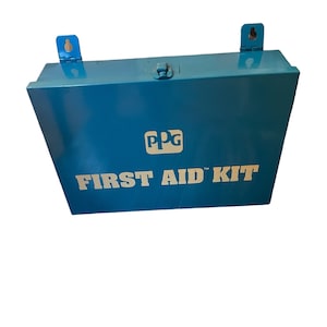 May include: A blue metal first aid kit with the text "FIRST AID KIT" and the PPG logo. The kit has a hinged lid and two metal brackets for wall mounting.