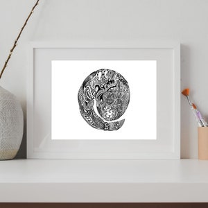 May include: A black and white framed print of a circular design with intricate details. The design is reminiscent of a spiral or a swirling pattern.