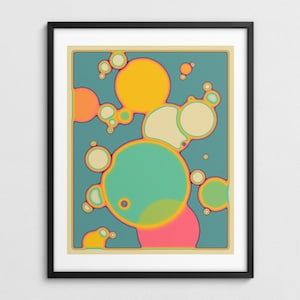 The image is a framed abstract artwork featuring a vibrant and colorful design of overlapping circles in various shades of green, orange, and pink.